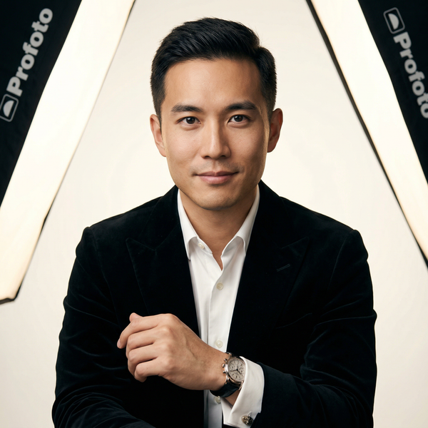 Studio high-key luxury headshot of wealthy Asian executive