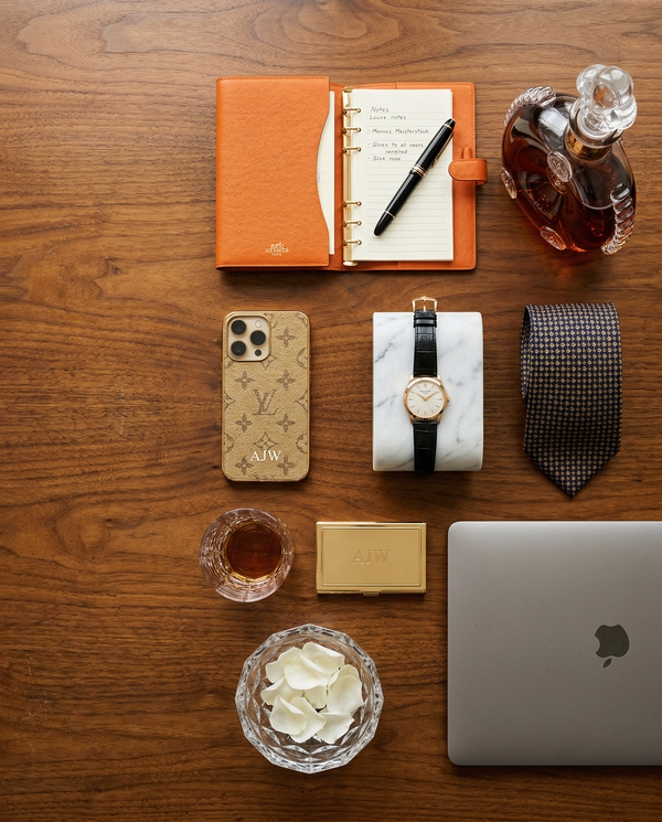 Luxury desk flatlay with Hermès agenda, Patek, Montblanc pen on walnut