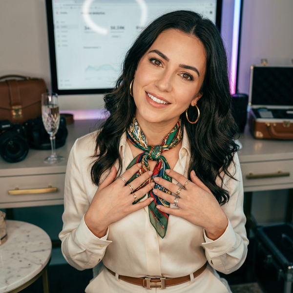 Studio close-up of female AI content creator under ring light with Gucci scarf