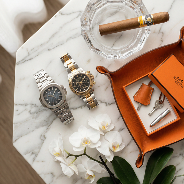 Patek and Rolex on Calacatta marble with Hermès tray
