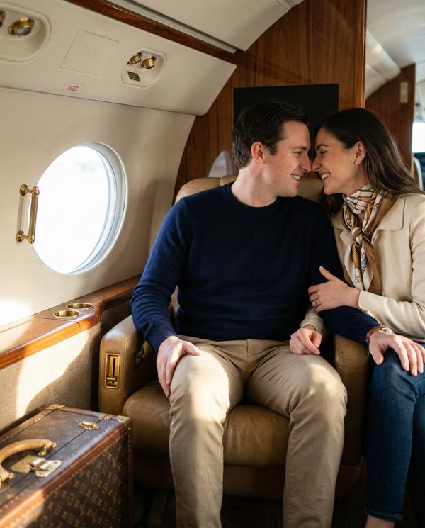 Affectionate couple in a private jet, embracing romance on an afternoon flight