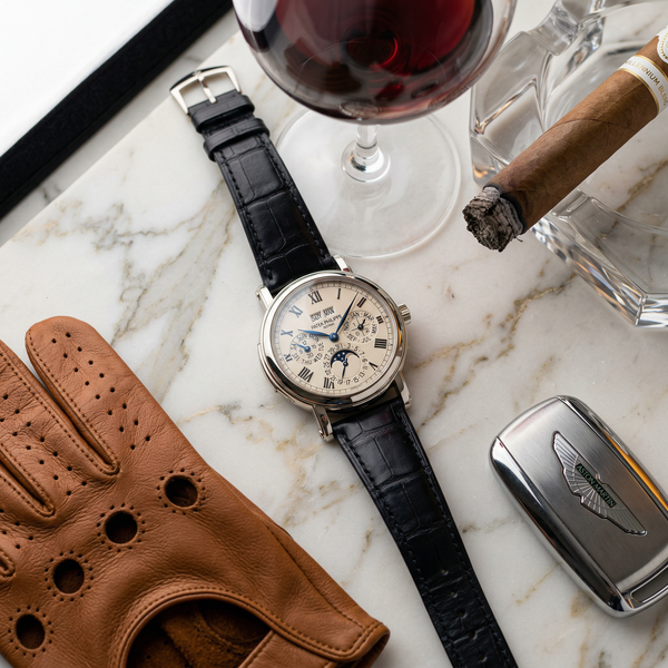 Patek Philippe watch on Calacatta marble with Hermes gloves