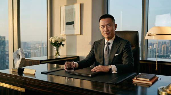 Executive penthouse office portrait with Tom Ford suit and Macassar desk