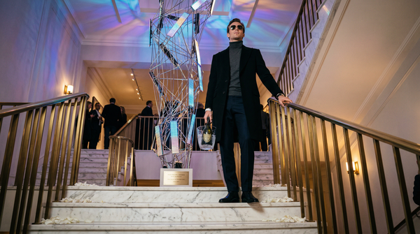 Low-angle view of collector on staircase beneath LED AI installation