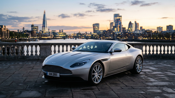Aston Martin DB11 at dawn with cityscape backdrop
