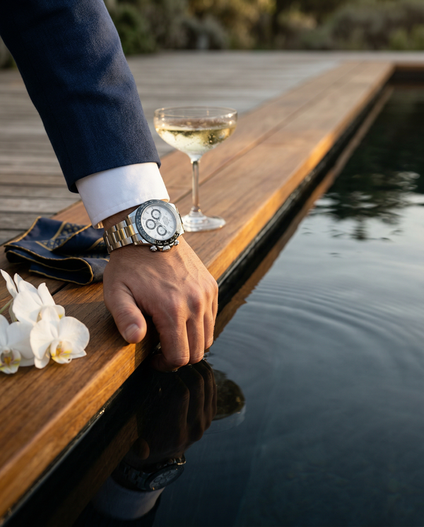 Rolex cuff close-up reflected in Bali infinity pool luxury