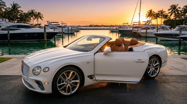 Luxury Bentley Continental GT at golden hour, showcasing elegant profile.