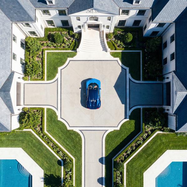 Overhead composition of Bugatti and mansion, showcasing opulent lifestyle elements.