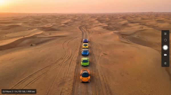 Overhead view of supercar convoy in desert, representing luxury automotive lifestyle.