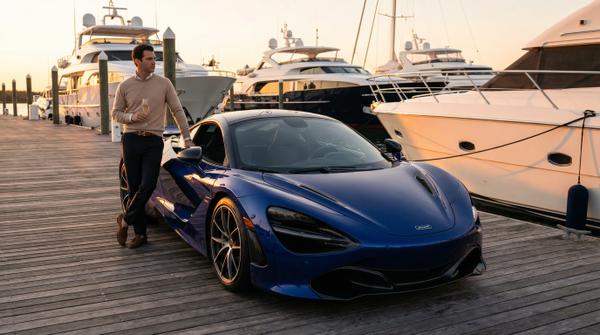 McLaren 720S at a chic yacht club, representing luxury supercar lifestyle.