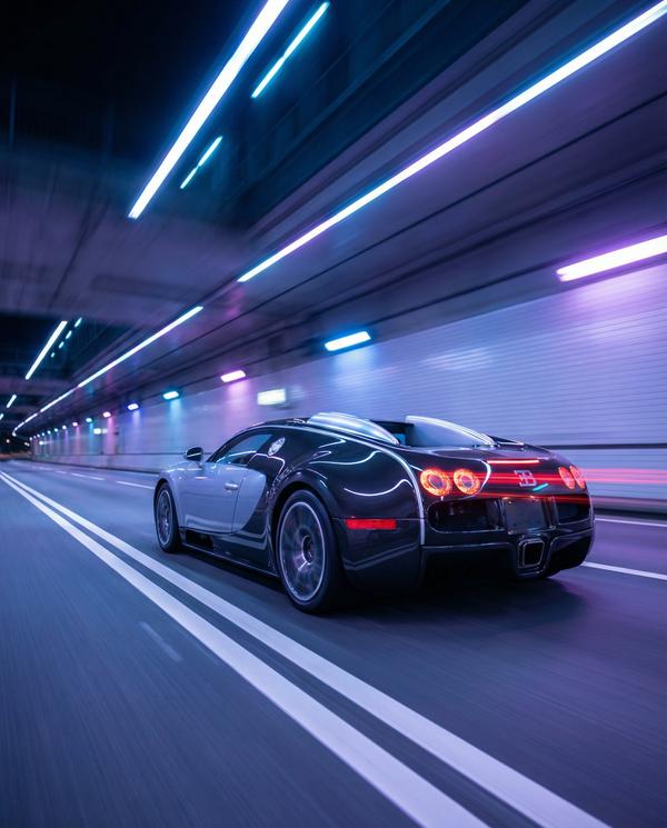 Bugatti Veyron racing through a luxury tunnel at night