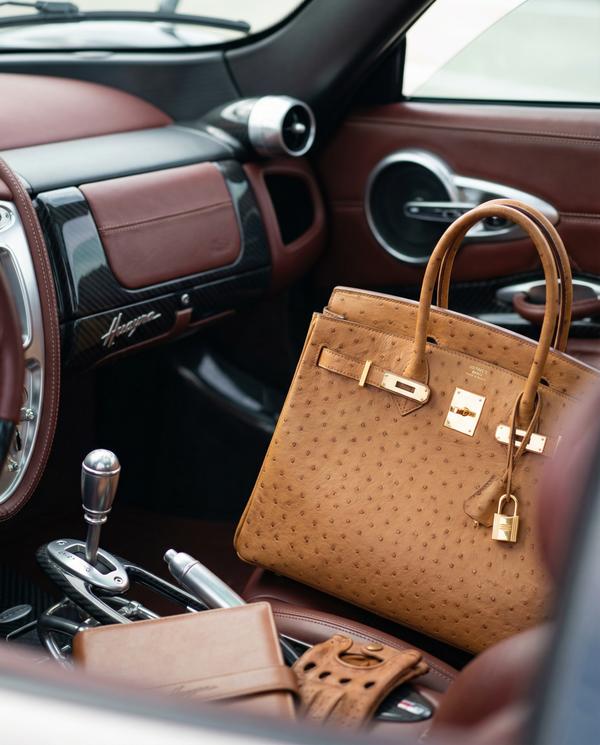 Glamorous accessory detail featuring a luxury watch against the Pagani's backdrop.