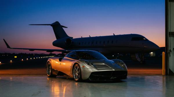 Private tarmac evening glow with a Pagani, creating a stunning luxury ambiance.