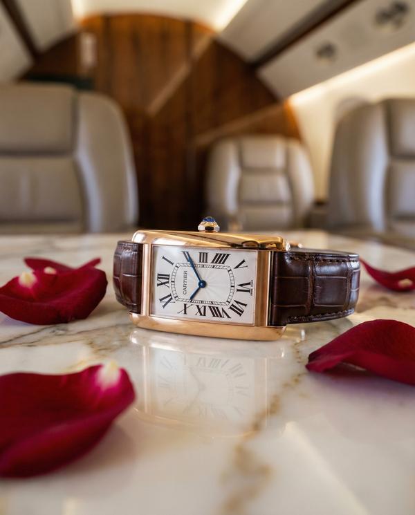 Detailed Cartier watch on a marble surface in luxury jet interior