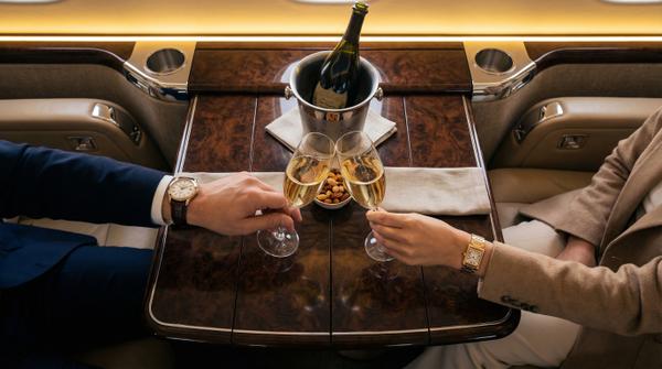 Champagne toast inside a private jet with overhead view