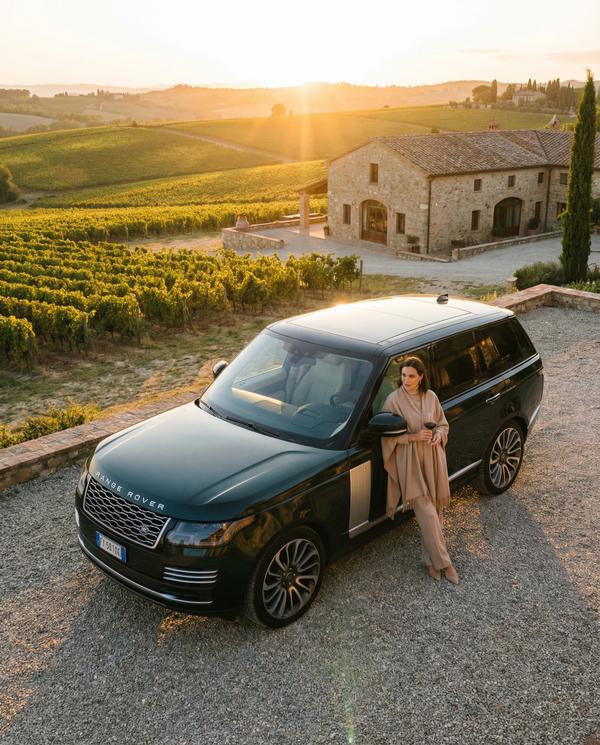 Range Rover driving through a scenic vineyard, epitome of luxury leisure