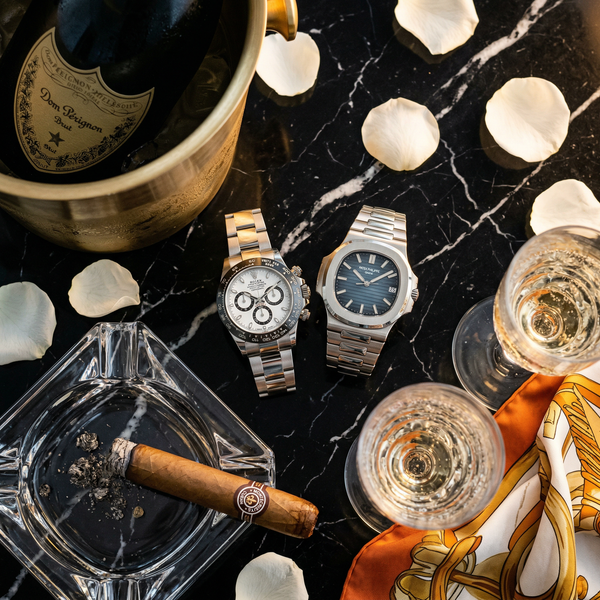 Close-up of Rolex and Dom Pérignon on Nero Marquina marble