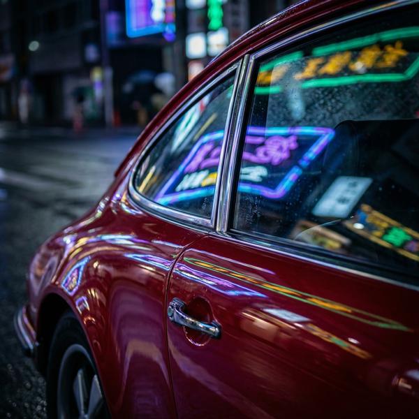 Detail shot of vintage Porsche reflecting light, luxury craftsmanship