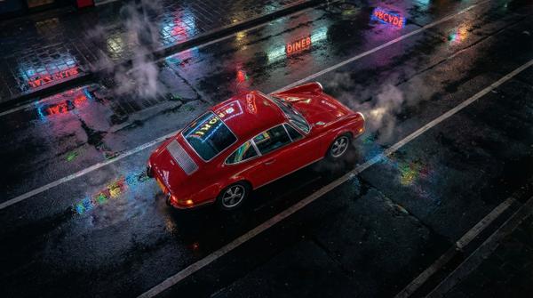 Overhead night view of vintage Porsche, capturing luxury allure